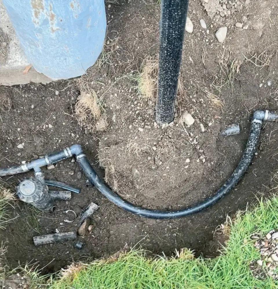 Sprinkler line being repaired in an open trench
